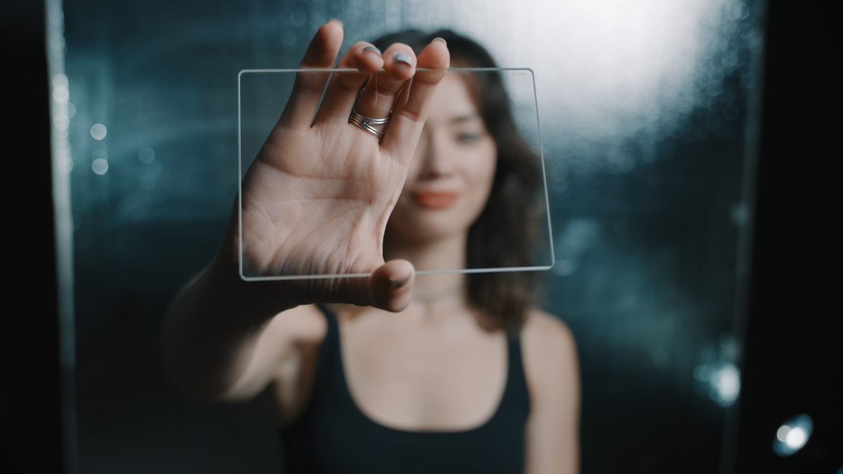 Person holding a Revar Cine rectangular clear filter in front of their face
