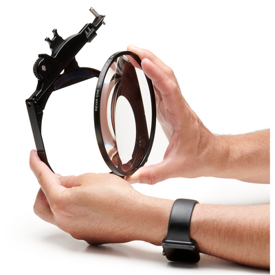 Hands placing a Revar Cine 138mm close-up diopter into a filter tray